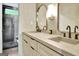 Modern bathroom featuring dual sinks, sleek fixtures, and a glass-enclosed walk-in shower at 129 Old Norton Rd, Fayetteville, GA 30215