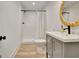Clean bathroom with a vanity, shower, toilet, and a round mirror at 129 Old Norton Rd, Fayetteville, GA 30215