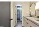 Stylish bathroom featuring a modern vanity, decorative mirror, and a glass-enclosed shower at 129 Old Norton Rd, Fayetteville, GA 30215
