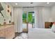 Bright bedroom with stylish dresser and French doors leading to a peaceful outdoor view at 129 Old Norton Rd, Fayetteville, GA 30215