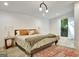 Inviting bedroom featuring a comfortable bed, stylish lighting, and serene backyard view at 129 Old Norton Rd, Fayetteville, GA 30215