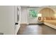 Bedroom with a decorative headboard, modern lamp, hardwood floors, and large window at 129 Old Norton Rd, Fayetteville, GA 30215