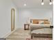 Modern bedroom with a wooden bed frame, soft bedding, and a full-length mirror at 129 Old Norton Rd, Fayetteville, GA 30215