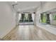 Spacious bonus room with wood floors, oversized windows with curtains, and a full wall mirror at 129 Old Norton Rd, Fayetteville, GA 30215