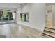 Bright bonus room features wood floors, oversized window with gray curtains, and a mirror at 129 Old Norton Rd, Fayetteville, GA 30215