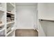 Bright walk-in closet features custom shelving and hardwood floors at 129 Old Norton Rd, Fayetteville, GA 30215