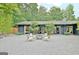 Inviting courtyard with a fire pit and seating, surrounded by lush palm trees and landscaping at 129 Old Norton Rd, Fayetteville, GA 30215
