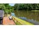 Inviting outdoor deck with seating area offers serene views of the adjacent pond at 129 Old Norton Rd, Fayetteville, GA 30215