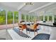 Bright dining area features modern lighting, lake views, and access to the deck with water access at 129 Old Norton Rd, Fayetteville, GA 30215