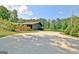 Wide concrete driveway leads to a gray home with an attached garage and lake views at 129 Old Norton Rd, Fayetteville, GA 30215
