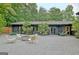 Charming backyard space with gravel, modern seating around a fire pit, and landscaping at 129 Old Norton Rd, Fayetteville, GA 30215