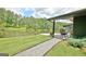 Stunning home exterior featuring a covered patio overlooking a serene lake at 129 Old Norton Rd, Fayetteville, GA 30215