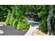 Exterior view of a guest house with lush landscaping, private drive, and outdoor patio at 129 Old Norton Rd, Fayetteville, GA 30215