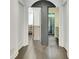 Hallway with hardwood floors showcasing a bathroom and storage room with unique sliding door feature at 129 Old Norton Rd, Fayetteville, GA 30215