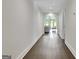 Hallway with wooden floors leading to a living area with a large arched window at 129 Old Norton Rd, Fayetteville, GA 30215
