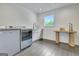 Laundry room with modern washer and dryer, white cabinets, and sleek hardwood flooring at 129 Old Norton Rd, Fayetteville, GA 30215