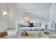 Cozy living room featuring a soft gray couch, stylish decor, and bright ambiance for relaxation at 129 Old Norton Rd, Fayetteville, GA 30215