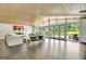Spacious living room featuring hardwood floors, wood ceiling, and large windows with a lake view at 129 Old Norton Rd, Fayetteville, GA 30215
