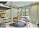 Home office with stylish furniture and a door leading to an outdoor seating area at 129 Old Norton Rd, Fayetteville, GA 30215