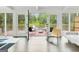 Bright sunroom with a view of the lake, hardwood floors, and white ceiling at 129 Old Norton Rd, Fayetteville, GA 30215