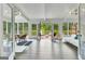 Light-filled sunroom featuring white ceilings, hardwood floors, and multiple windows at 129 Old Norton Rd, Fayetteville, GA 30215