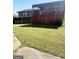 Green backyard featuring a home exterior and raised deck, perfect for outdoor enjoyment at 2574 Rosedale Dr, Morrow, GA 30260