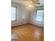 Bedroom with hardwood floors, ceiling fan, and large windows that bring in a lot of natural light at 2574 Rosedale Dr, Morrow, GA 30260