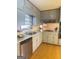 Well-lit kitchen features wood floors, granite countertops, gray cabinets, and stainless steel dishwasher at 2574 Rosedale Dr, Morrow, GA 30260