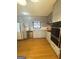 Well-lit kitchen features wood floors, granite countertops, gray cabinets, and stainless steel dishwasher at 2574 Rosedale Dr, Morrow, GA 30260