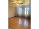 Living room with hardwood floors and large windows that bring in a lot of natural light at 2574 Rosedale Dr, Morrow, GA 30260