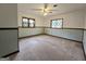 Spacious bedroom with wall trim, ceiling fan, and two windows letting in natural light at 2996 Jodeco Dr, Jonesboro, GA 30236