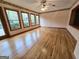 Spacious living room with hardwood floors, large windows, and a ceiling fan at 2996 Jodeco Dr, Jonesboro, GA 30236