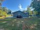Expansive backyard featuring a well-maintained lawn and charming blue siding exterior at 710 Bluebird Se Dr, Conyers, GA 30094