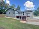 Exterior view of a backyard with a deck, grass, and gravel at 710 Bluebird Se Dr, Conyers, GA 30094