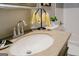 Bathroom vanity with a granite countertop, modern faucet, and decorative accents at 710 Bluebird Se Dr, Conyers, GA 30094