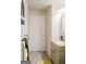 Neutral-toned bathroom with modern vanity, decorative fixtures, and stylish yellow accents at 710 Bluebird Se Dr, Conyers, GA 30094
