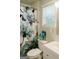 Bright bathroom with a floral shower curtain and a clean white vanity and toilet at 710 Bluebird Se Dr, Conyers, GA 30094