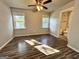 Well-lit bedroom showcasing laminate floors, neutral walls, and an attached bathroom at 710 Bluebird Se Dr, Conyers, GA 30094