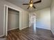 Bedroom with closet, ceiling fan and hardwood floors at 710 Bluebird Se Dr, Conyers, GA 30094