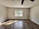 Spacious bedroom featuring wood-look flooring and a bright window at 710 Bluebird Se Dr, Conyers, GA 30094