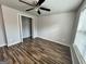 Bedroom features wood-look flooring, a ceiling fan, and closet at 710 Bluebird Se Dr, Conyers, GA 30094