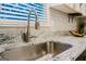 Close-up of a stainless steel kitchen sink, with granite countertop and window at 710 Bluebird Se Dr, Conyers, GA 30094