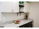 Close-up on a white countertop with granite, decor, and white cabinets at 710 Bluebird Se Dr, Conyers, GA 30094