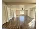 Open-concept living room with wooden floors, neutral walls, and natural light at 710 Bluebird Se Dr, Conyers, GA 30094