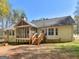 Spacious home showcasing a screened porch, wooden deck, and large backyard at 115 Christie Ln, Mcdonough, GA 30252