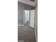 Walk-in closet featuring new carpeting, white trim, and closet rod for hanging clothes at 9487 Lakeview Rd, Union City, GA 30291