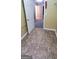 Hallway with modern flooring, white trim, and neutral walls leads to adjoining rooms at 9487 Lakeview Rd, Union City, GA 30291