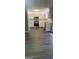 Modern kitchen with white cabinets, stainless steel appliances, and hard surface floors at 9487 Lakeview Rd, Union City, GA 30291