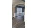 Bright living room with detailed wainscoting, hard surface floors, and a large window at 9487 Lakeview Rd, Union City, GA 30291