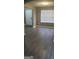 Open living room with hardwood floors, window and a white door at 9487 Lakeview Rd, Union City, GA 30291